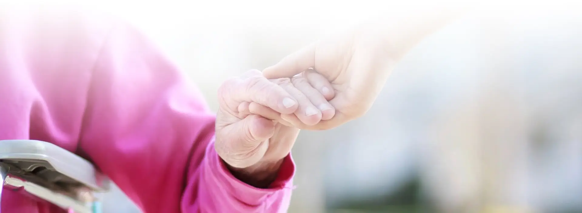 A person holding another persons hand in their hands.