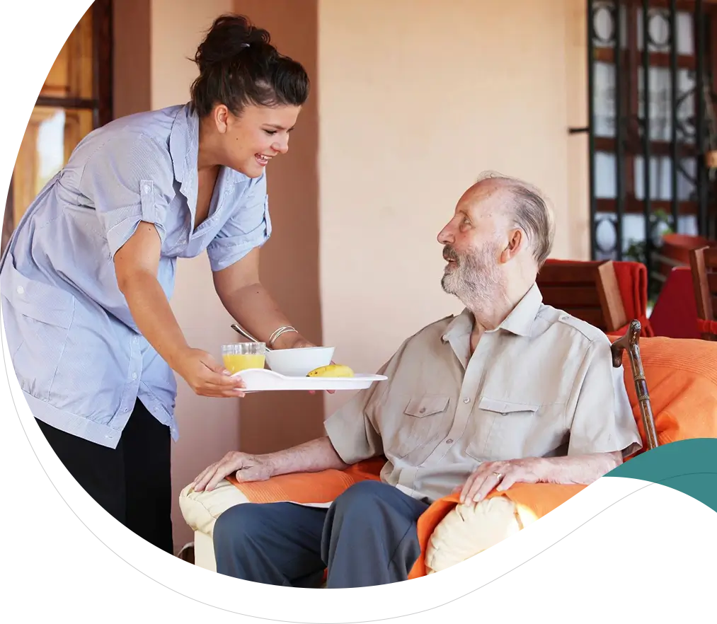 A nurse is handing food to an elderly man.