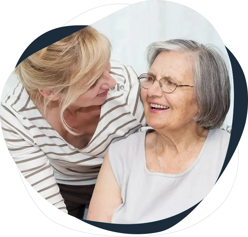 A woman and an older person smiling for the camera.